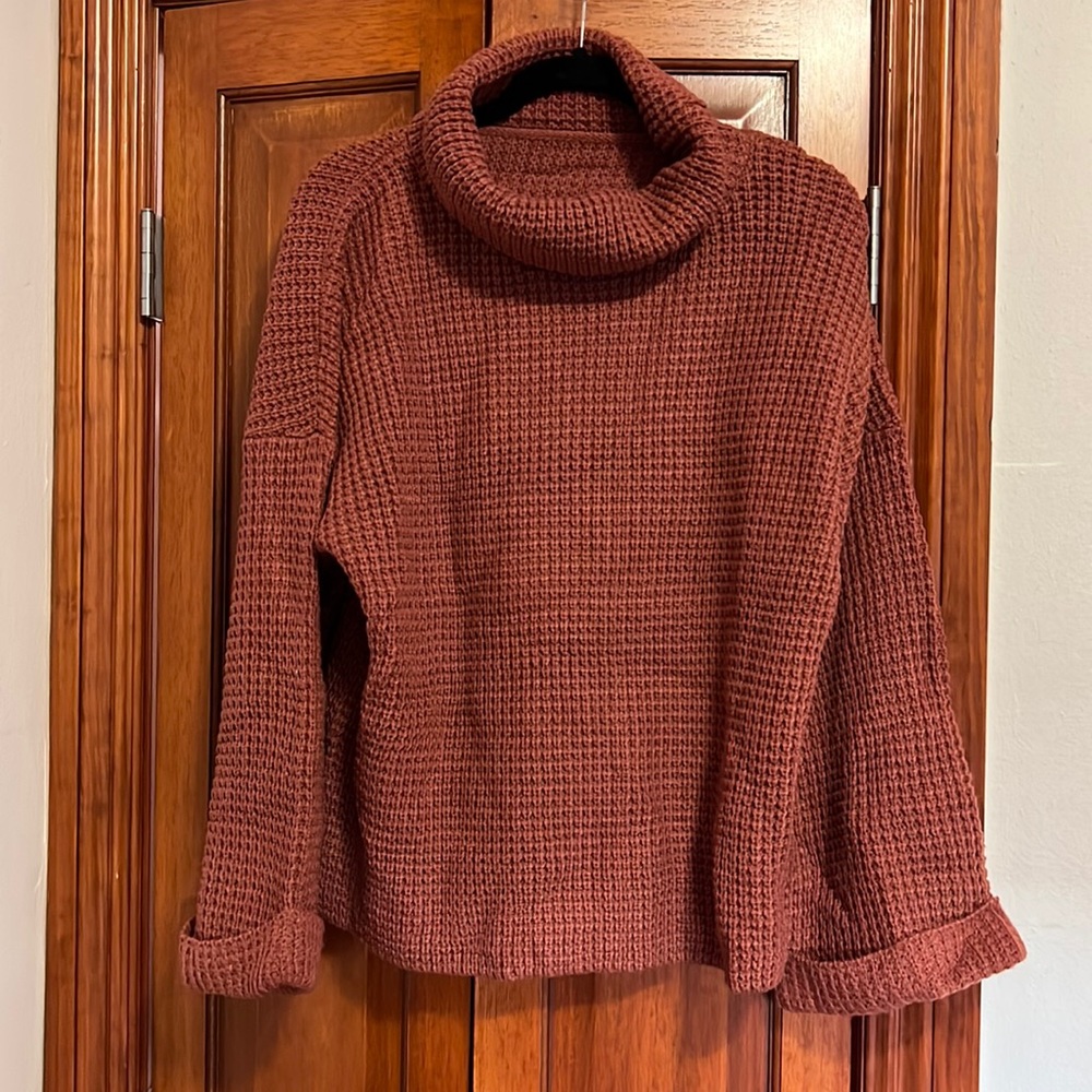 Oversized waffle knit, turtle neck sweater with bell sleeves.